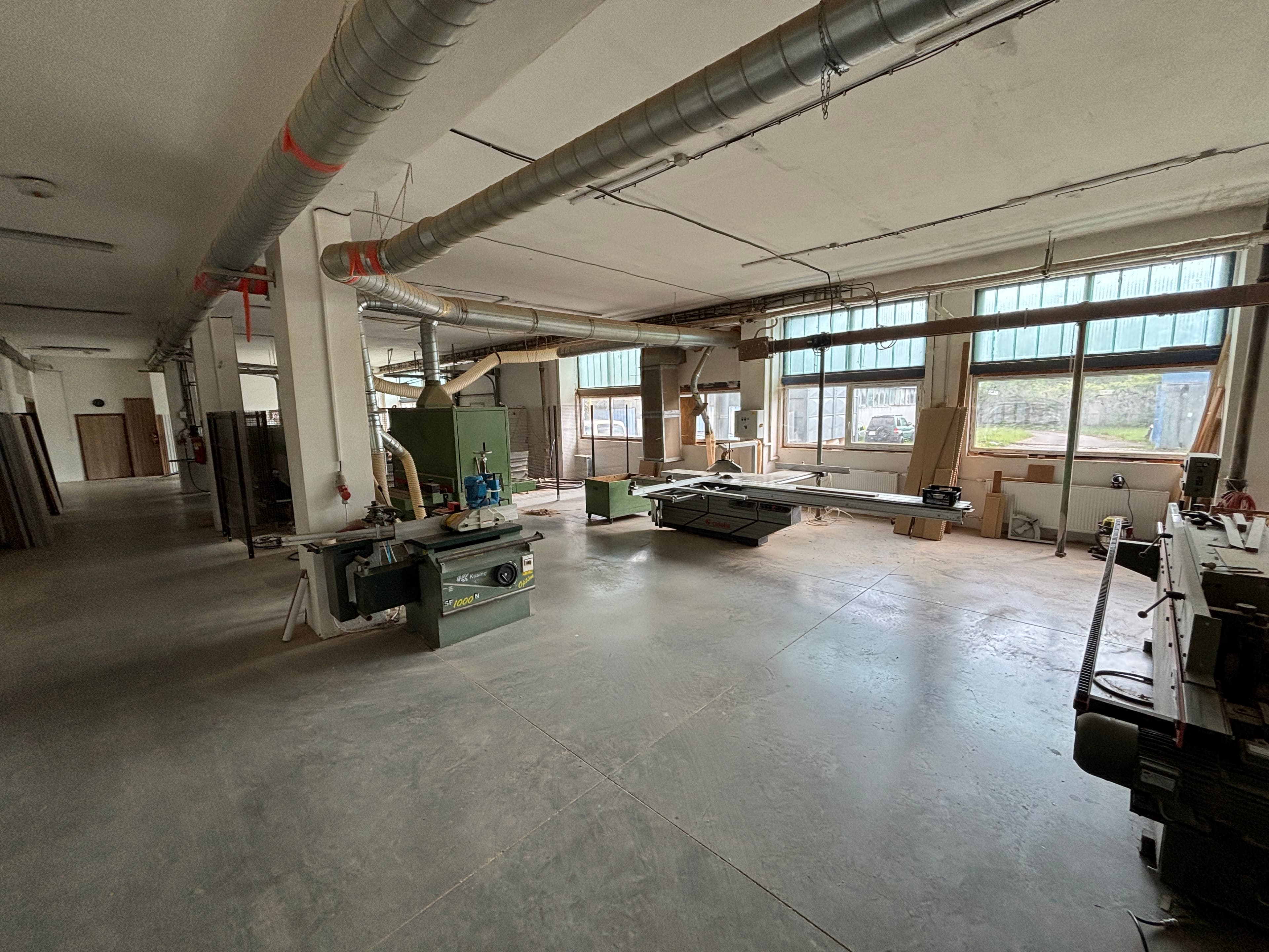 Workshop overview with a sliding table saw and spindle moulder