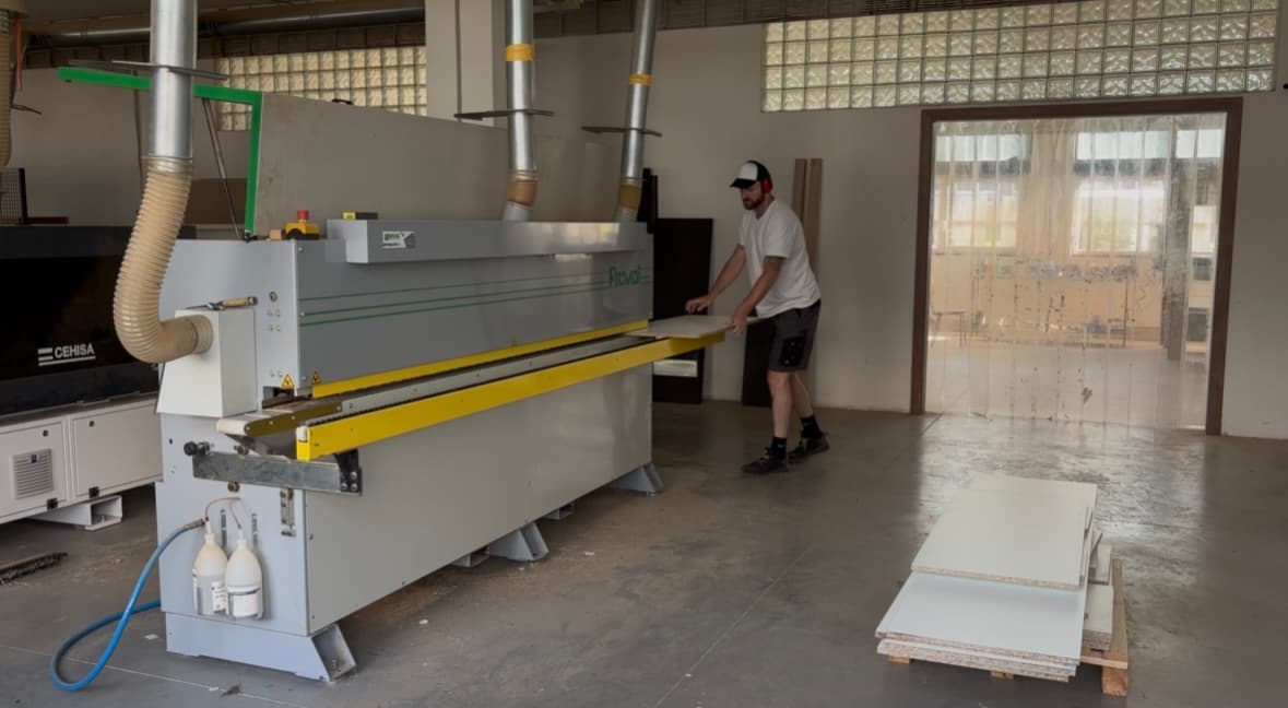 Tom feeding a panel into the edge banding machine