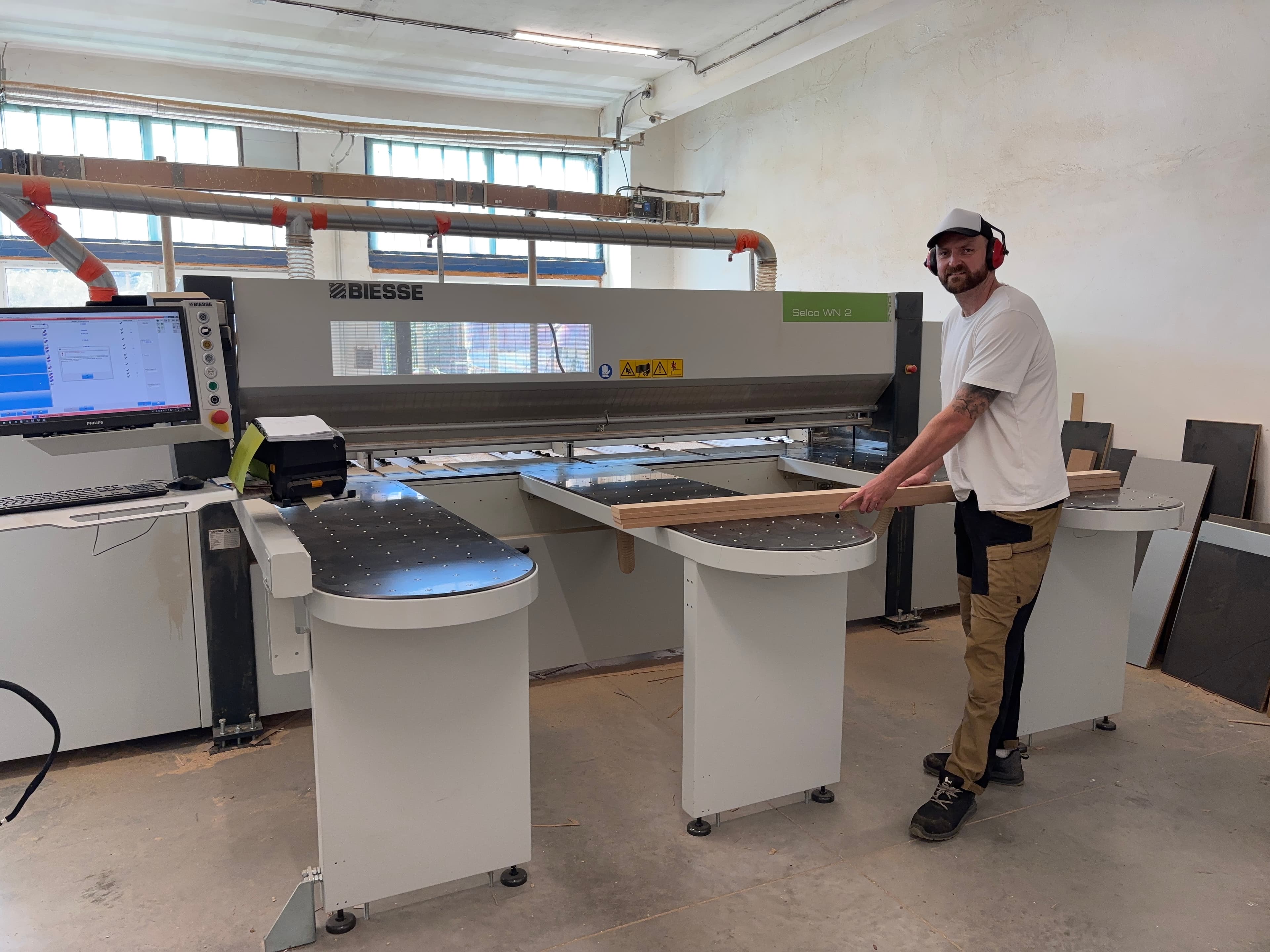 Tom loading a board onto the Biesse Selco panel saw